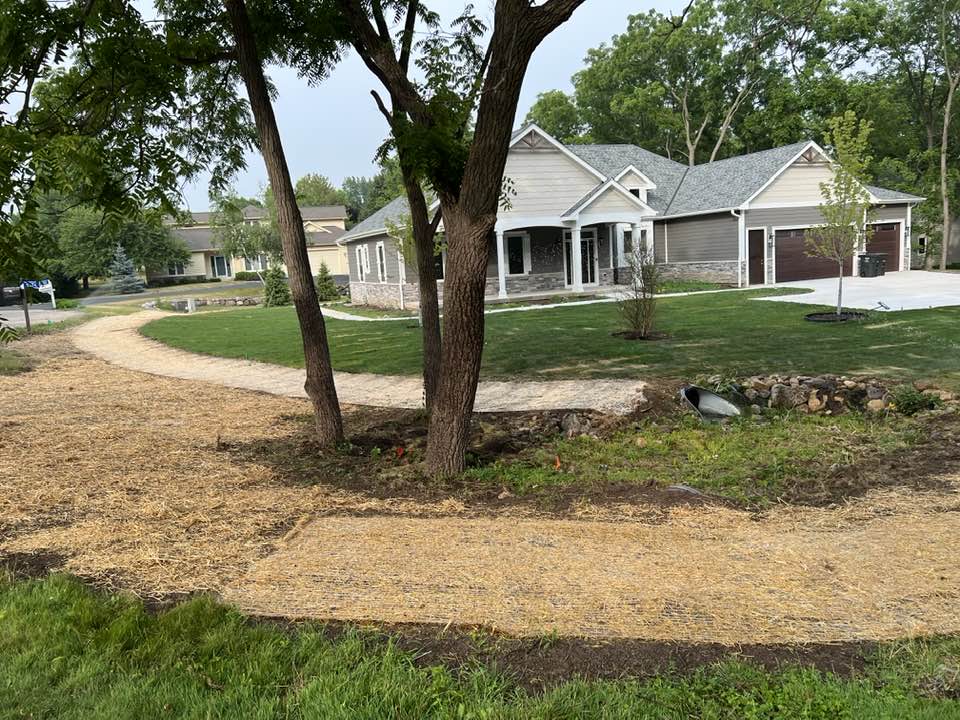 Seasonal landscape cleanup and fresh planting beds around a home